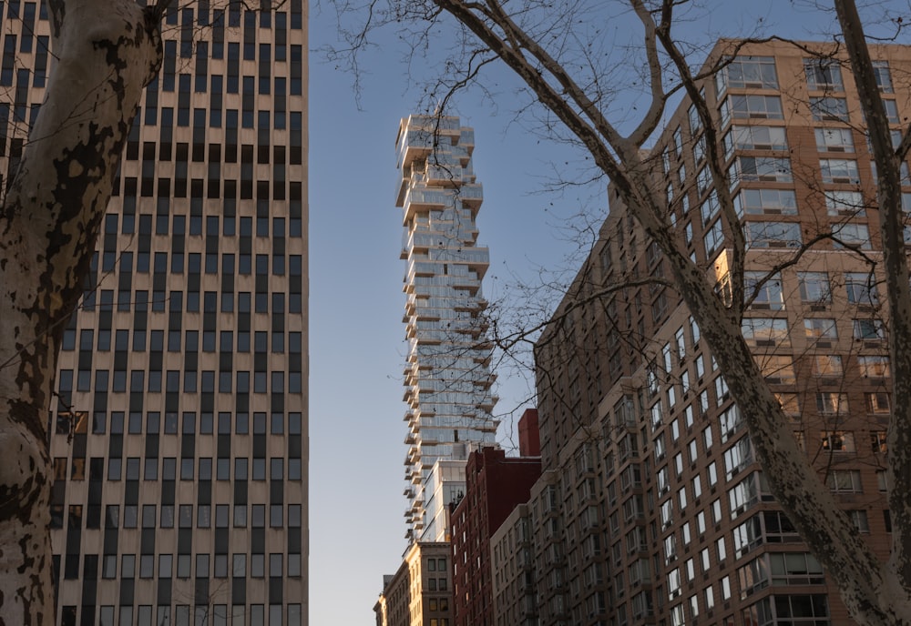 a couple of tall buildings sitting next to each other