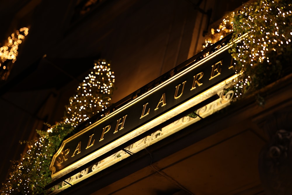 a sign that is lit up with christmas lights