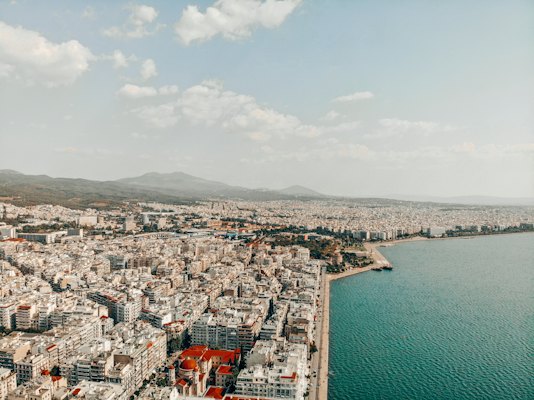 An aerial view of a large city next to a body of water — Nafplio, Greece
