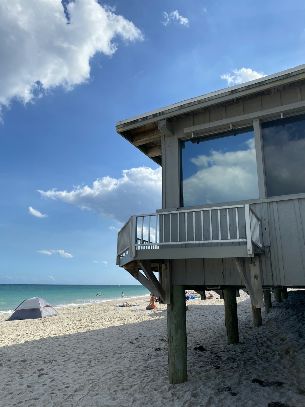 a house on the beach with a view of the ocean