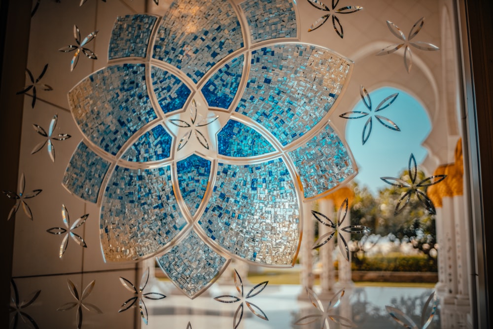 a glass window with a blue flower on it