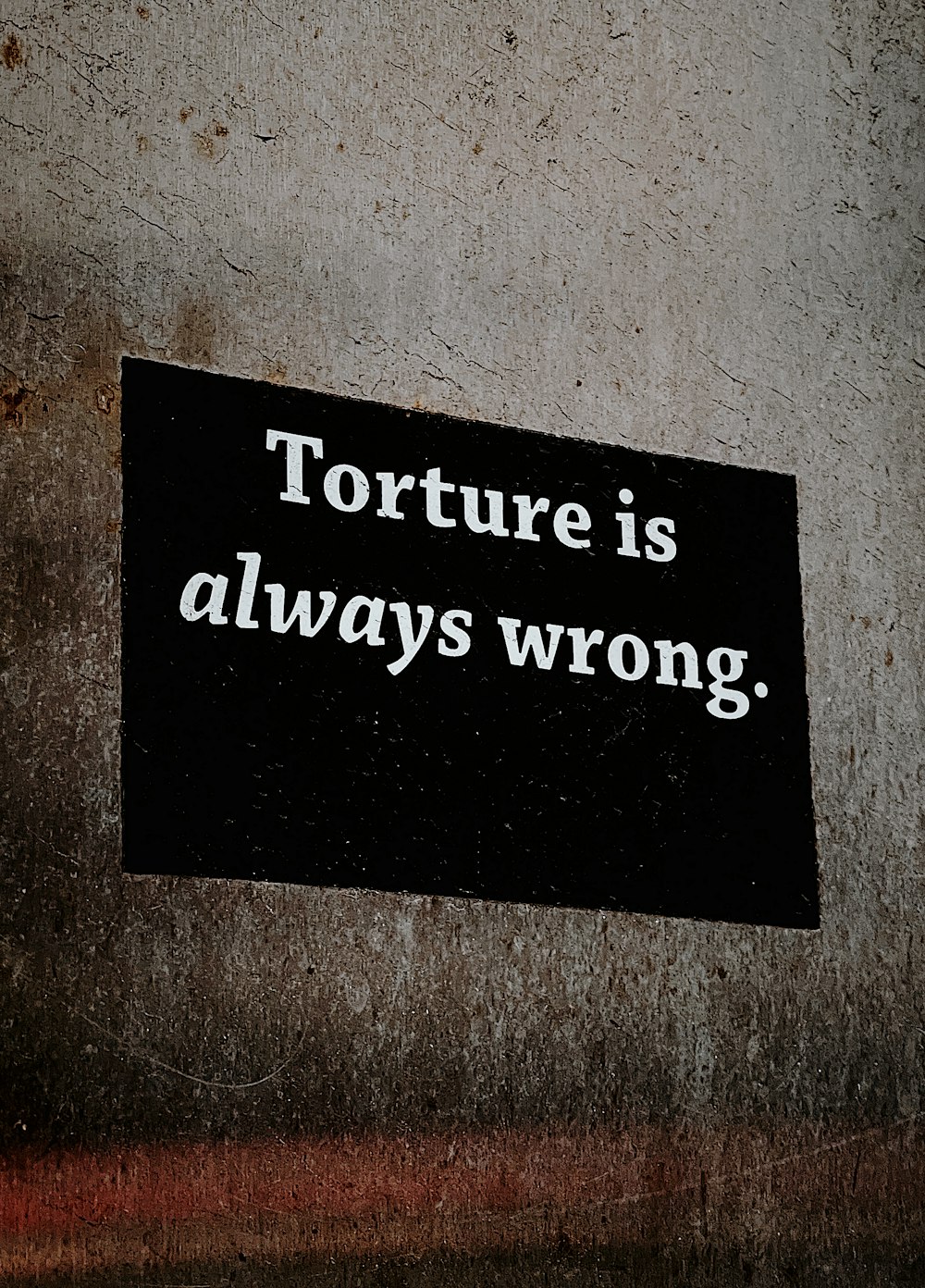 a sign on a wall that says torture is always wrong