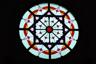 a circular stained glass window with hearts on it