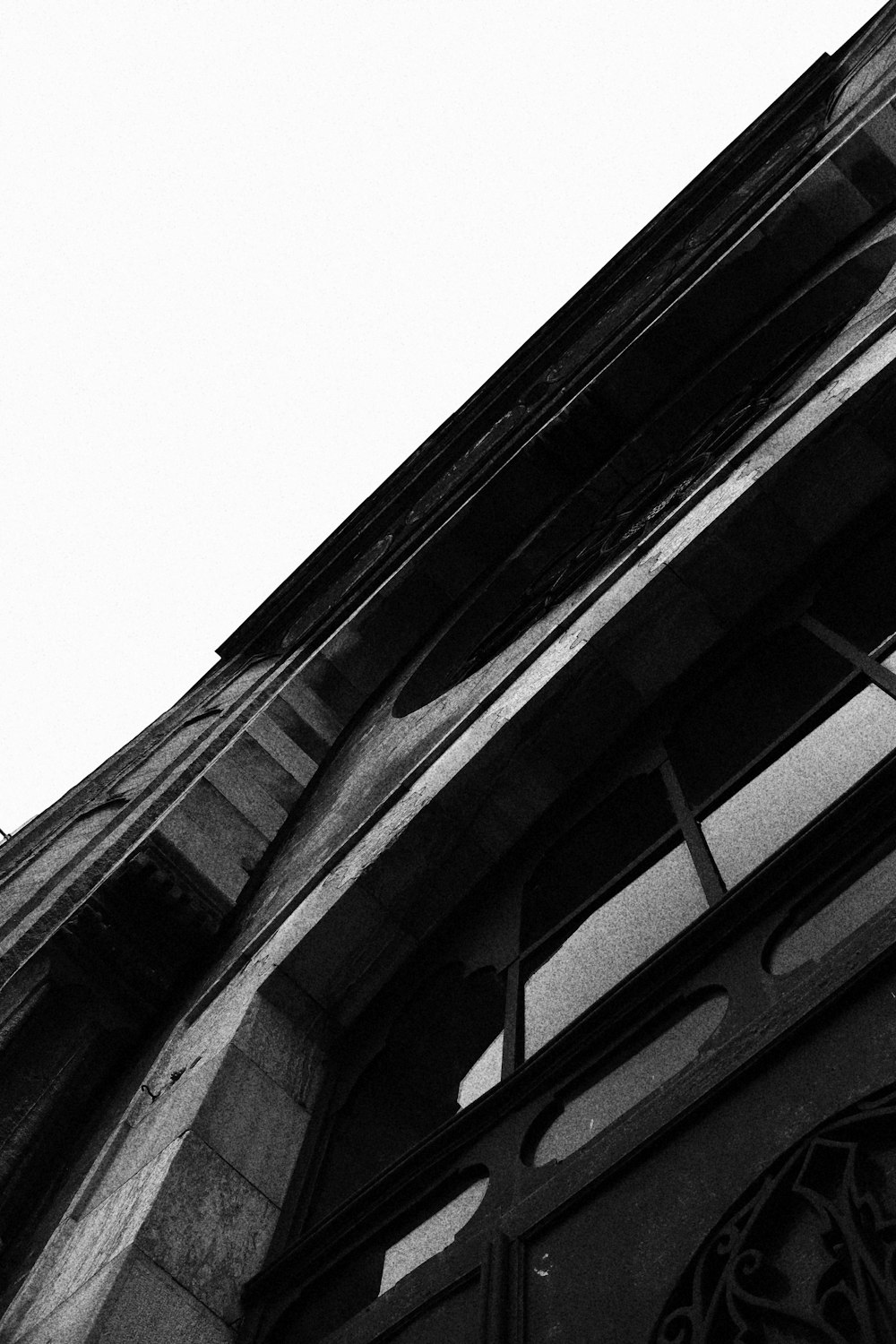 a black and white photo of a clock on the side of a building