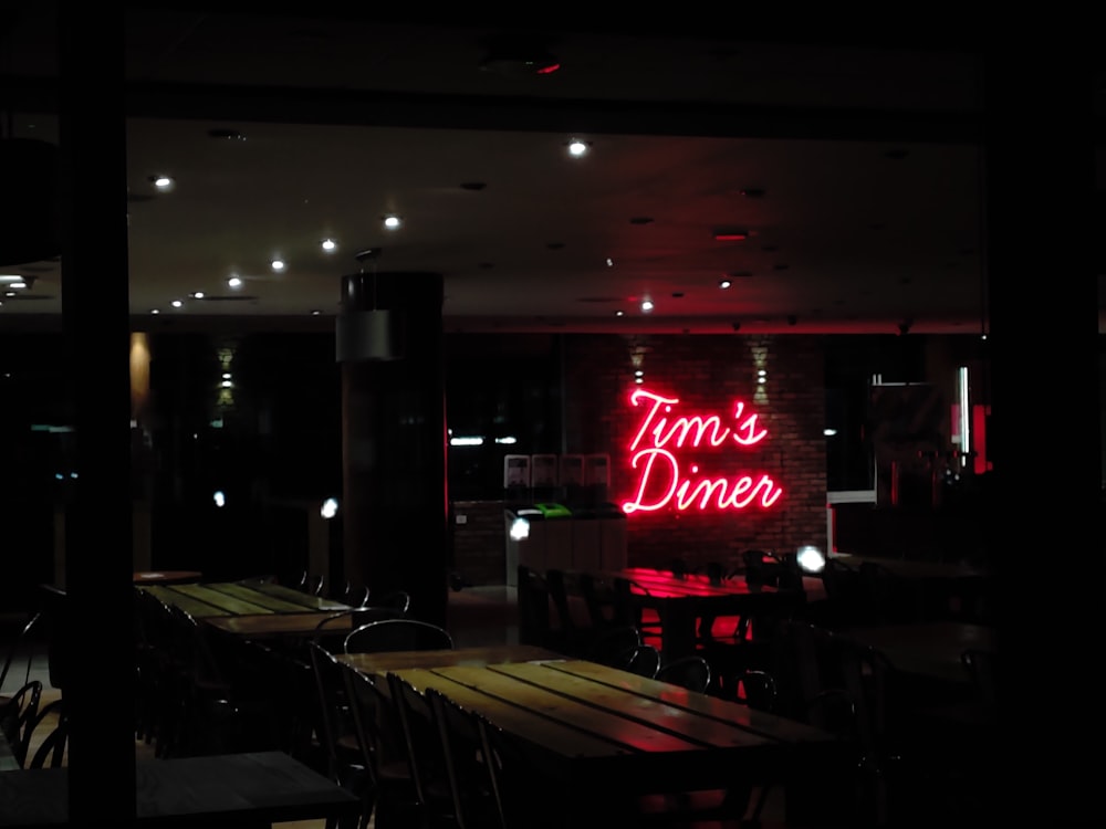 a restaurant with a neon sign that says tom's diner