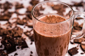 a glass mug filled with a chocolate drink