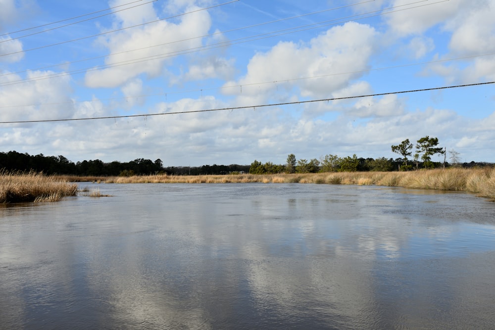 a body of water with power lines above it