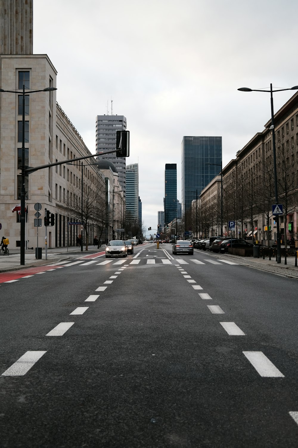 a city street with a few cars driving down it