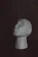a white mannequin head sitting on a table