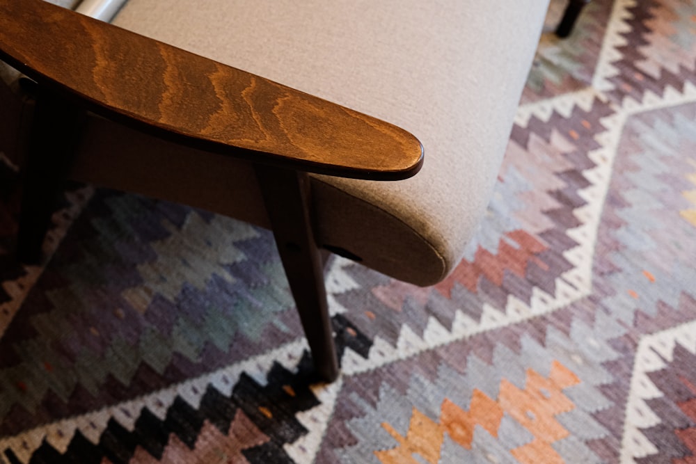 a close up of a chair with a wooden seat