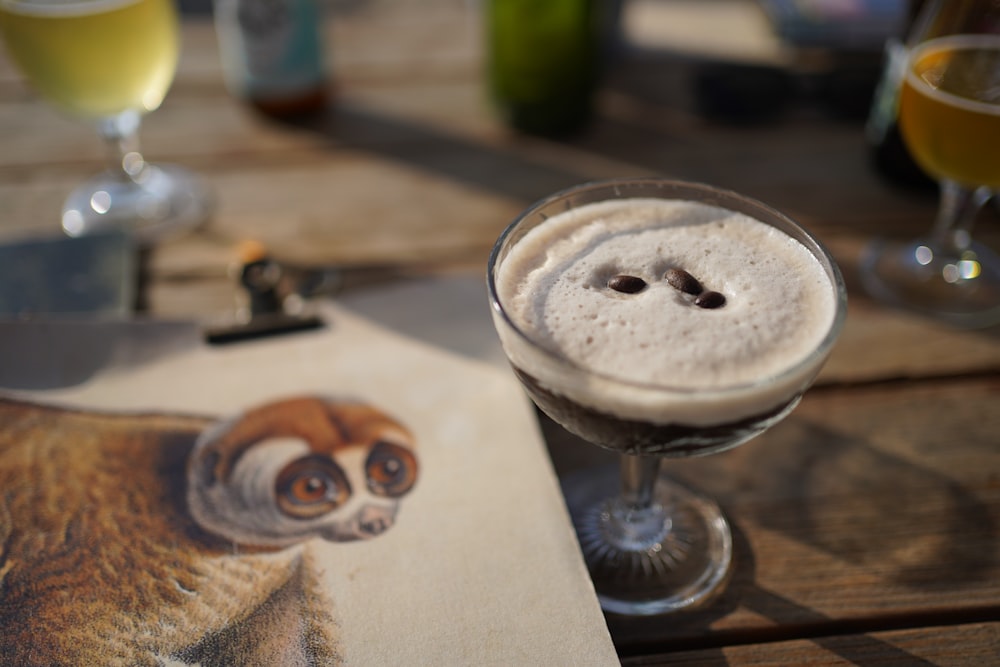 a picture of a monkey on a piece of paper next to a drink