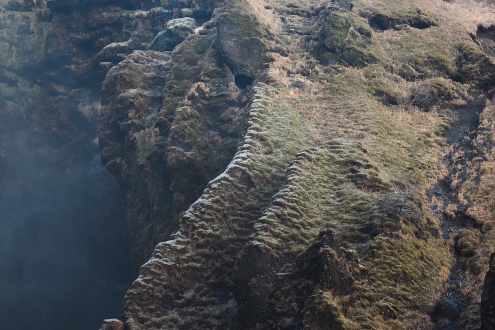 an aerial view of a rocky area with grass growing on it