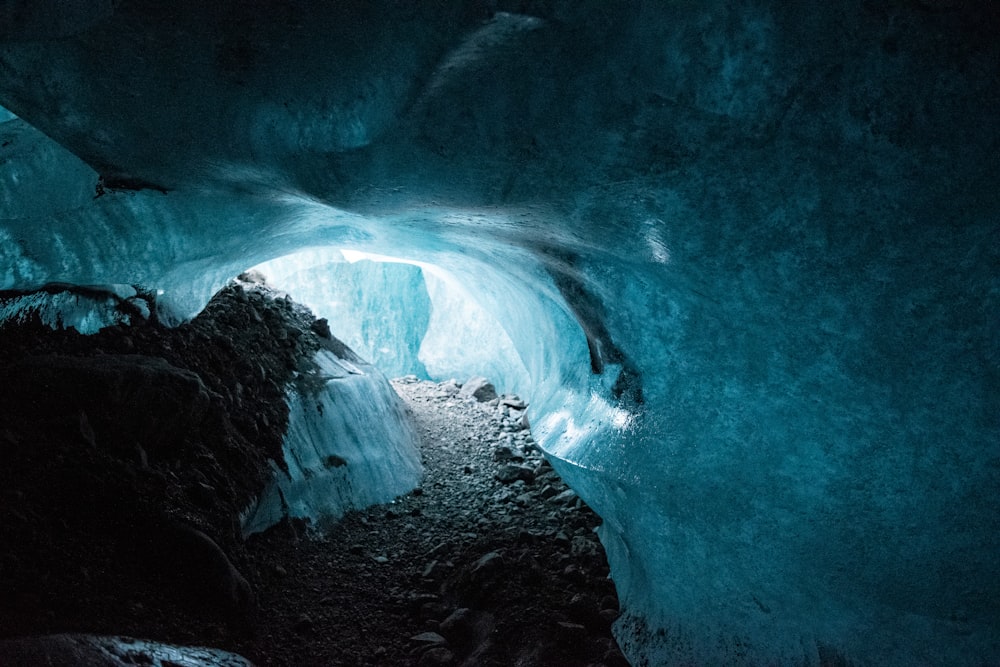 a large ice cave with a light at the end