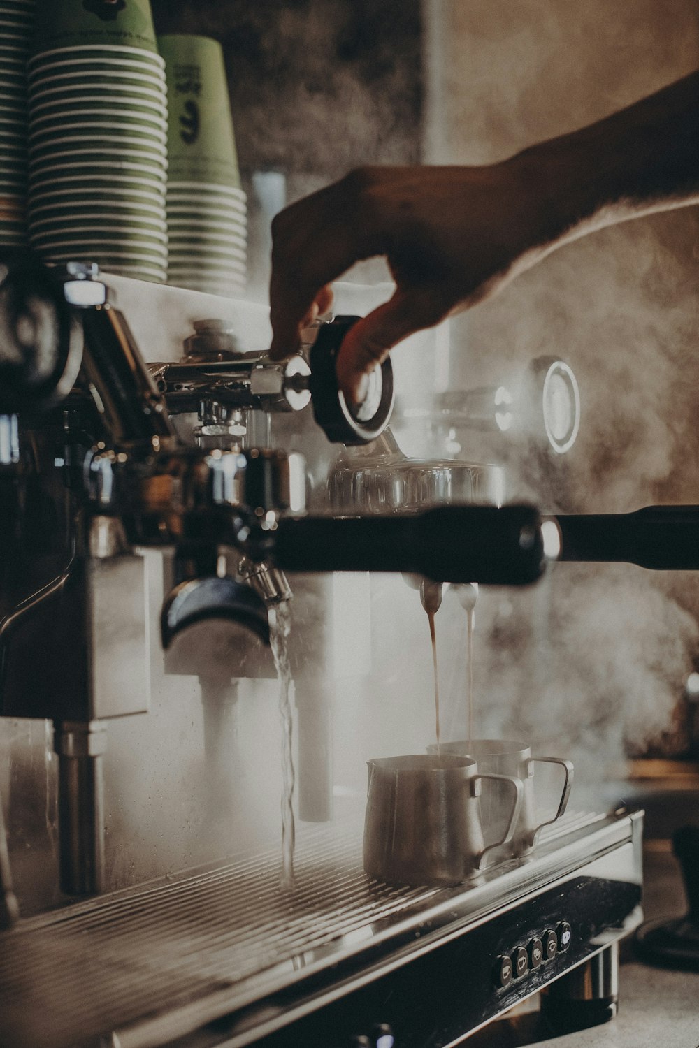 a person is pouring coffee into a cup