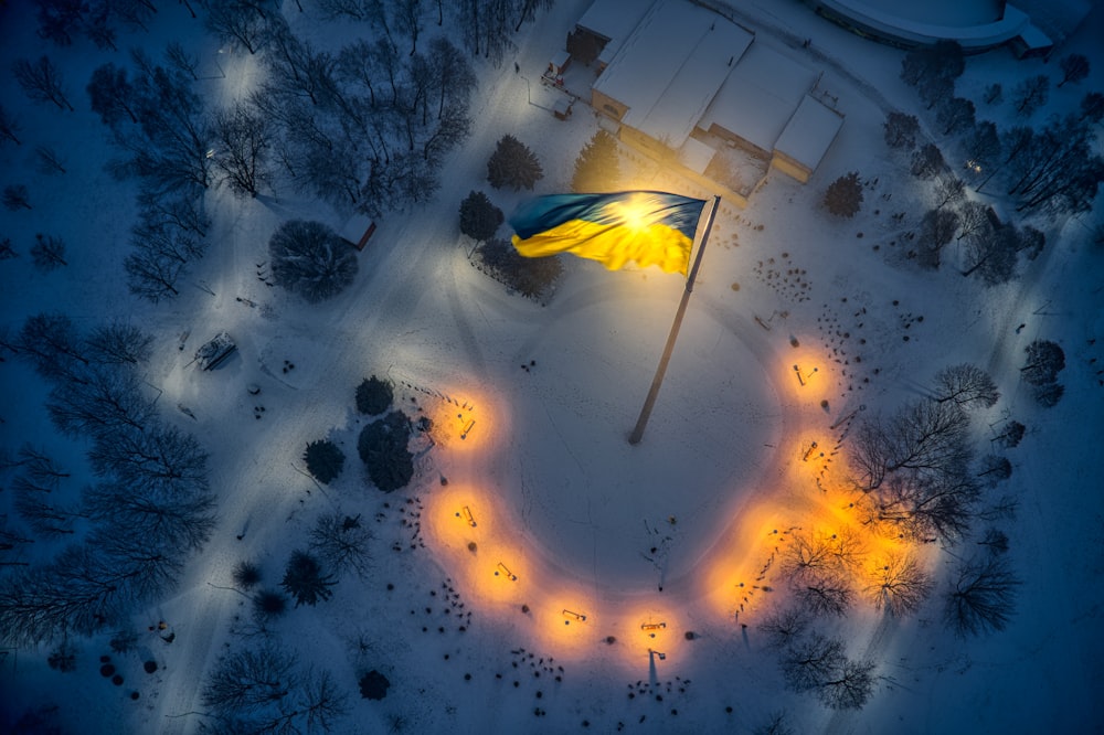 a yellow and blue flag is in the middle of a circle of lights