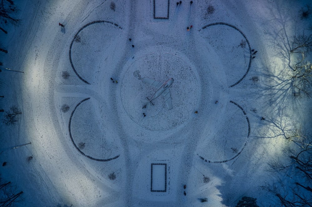 an aerial view of a clock in the snow