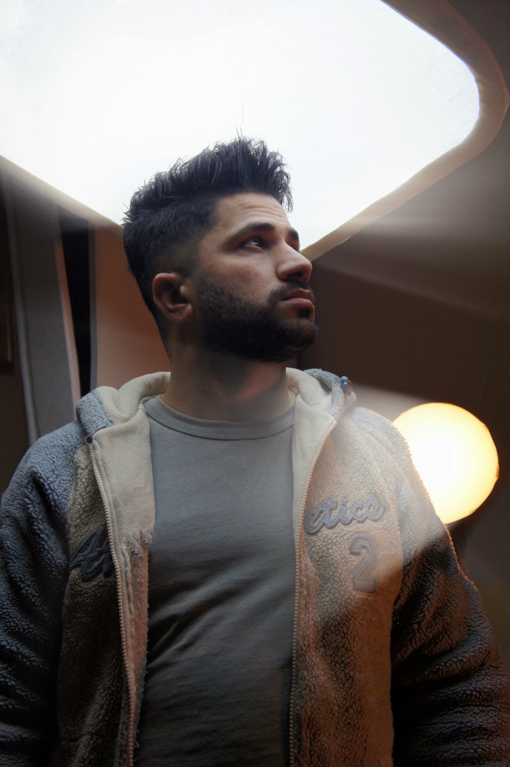 a man standing in front of a ceiling light