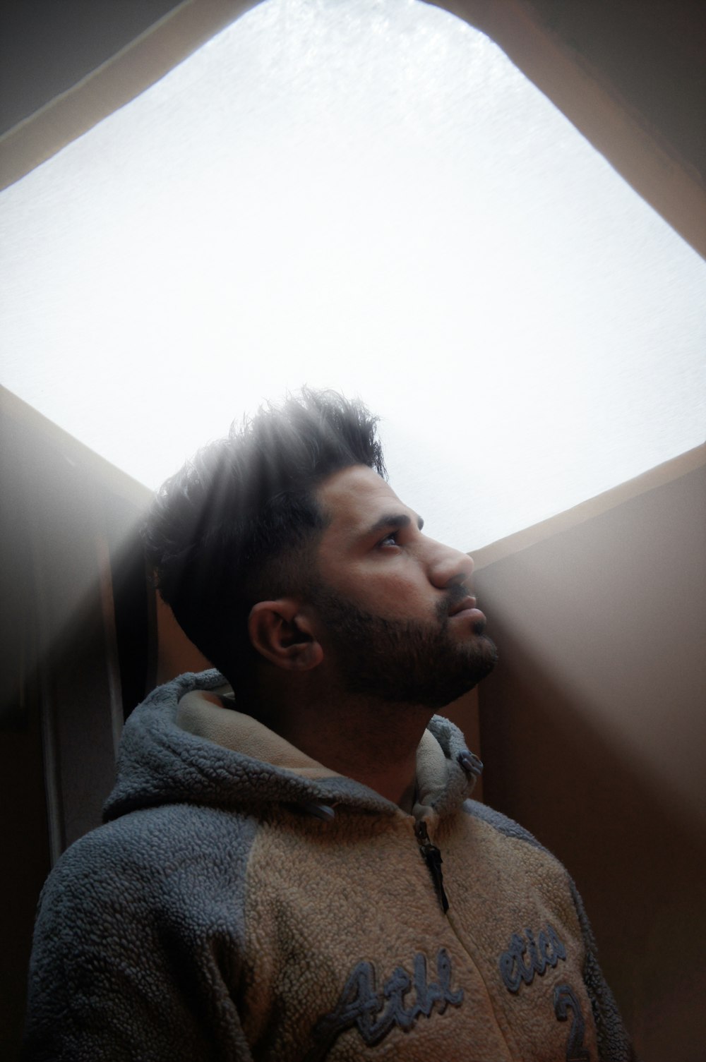 a man standing in front of a skylight