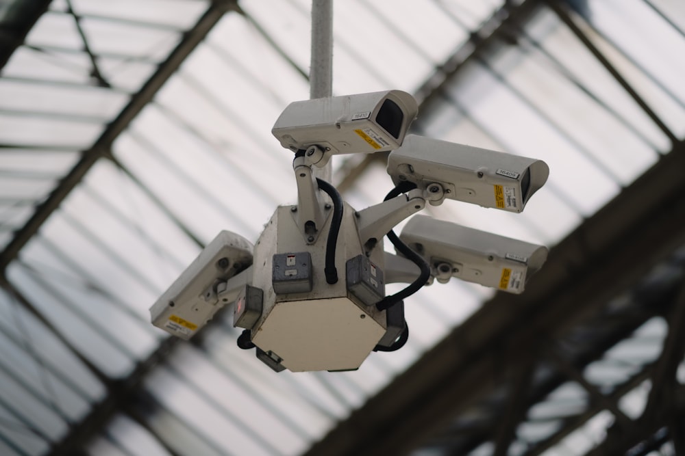 a bunch of surveillance cameras hanging from a ceiling