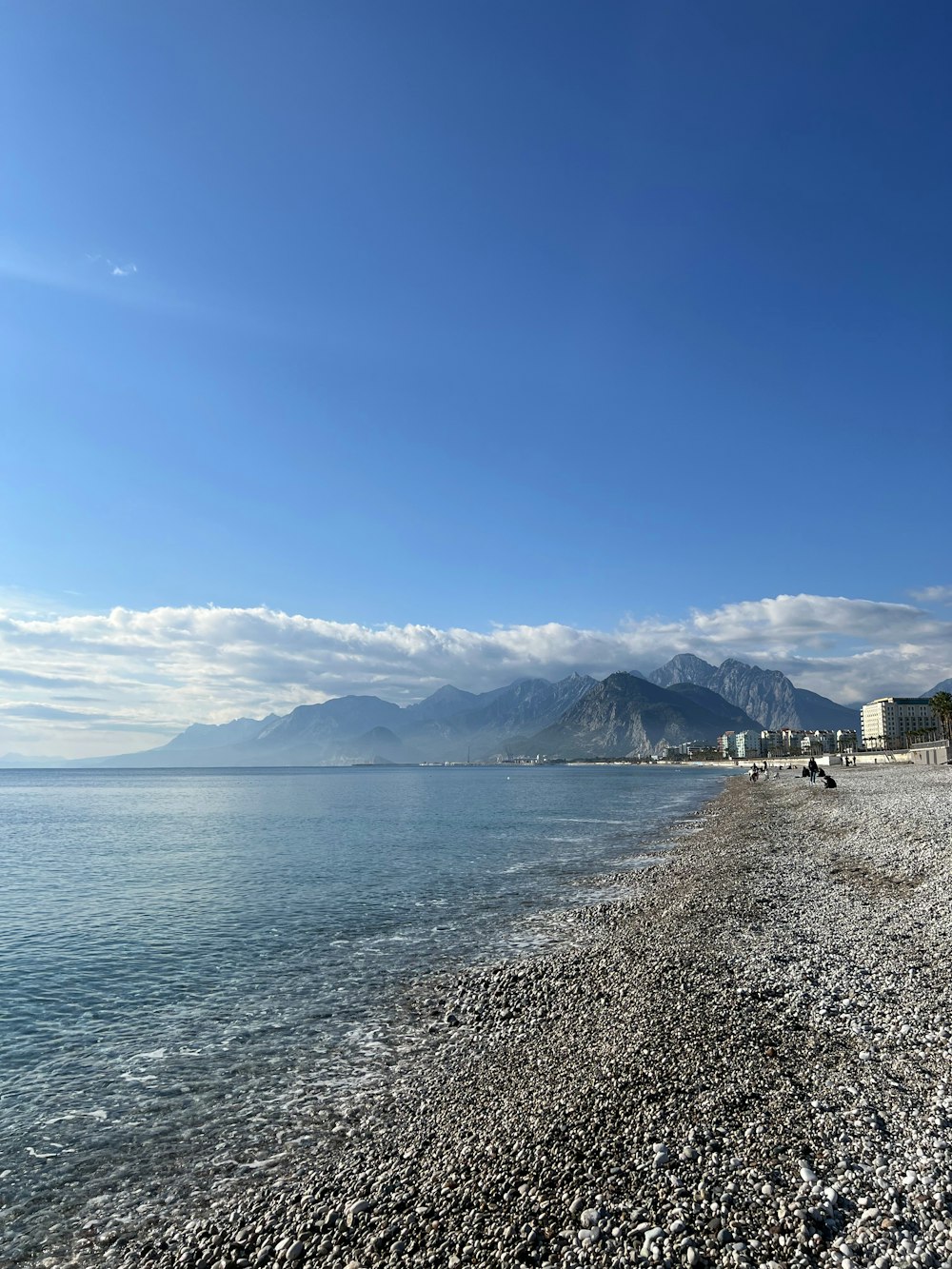 a view of a beach with mountains in the background