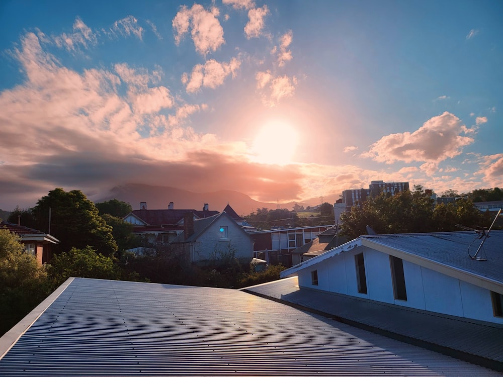 the sun is setting over a residential area