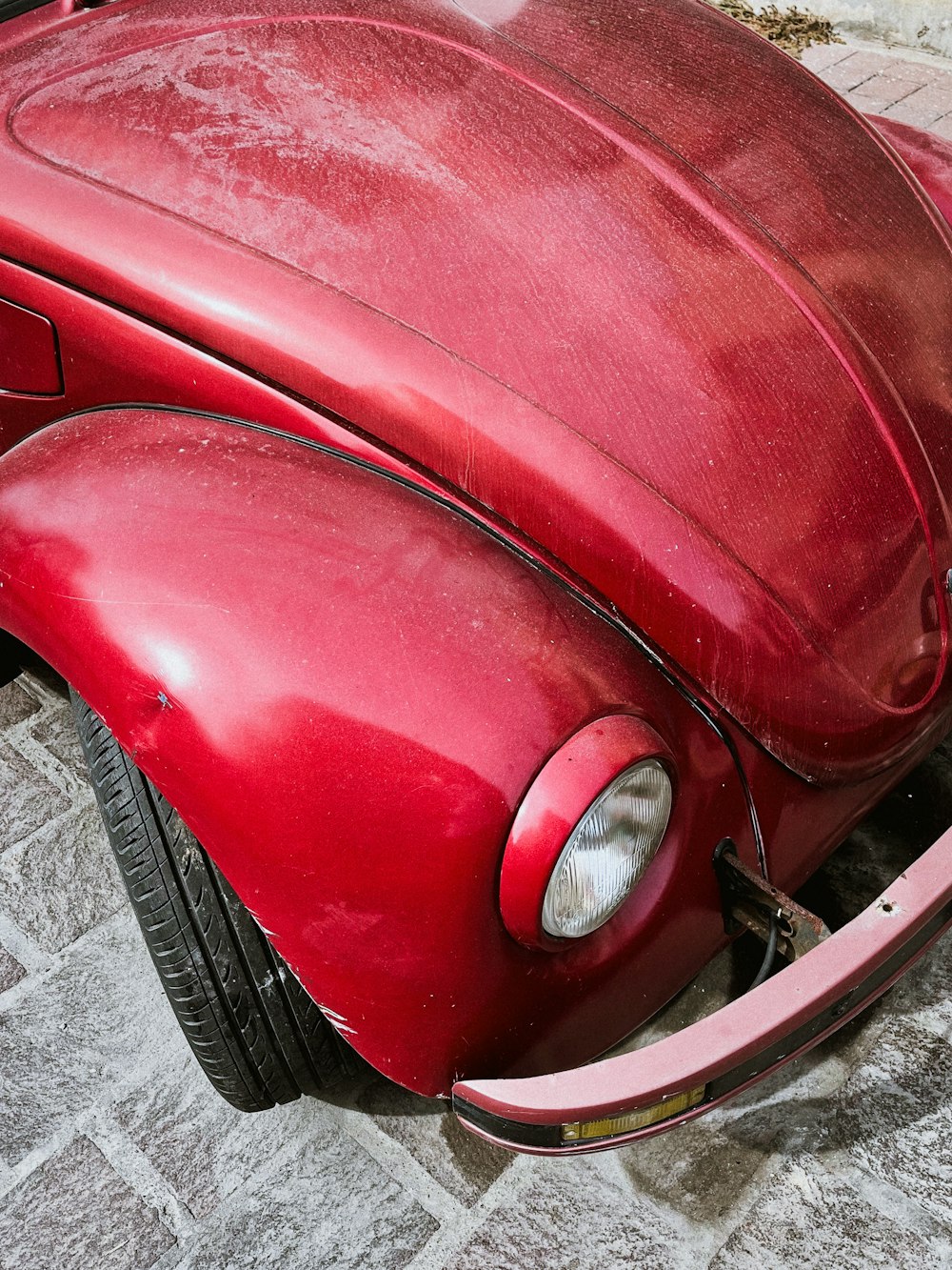 a close up of the front end of a red car