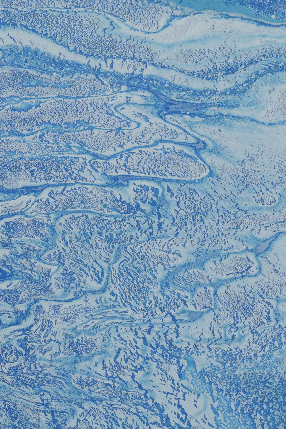 a blue and white painting of water and land