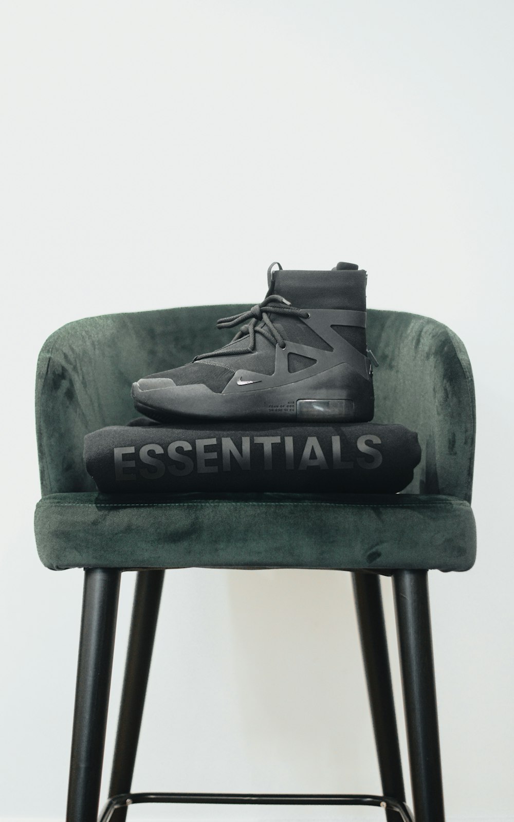 a pair of shoes sitting on top of a green chair