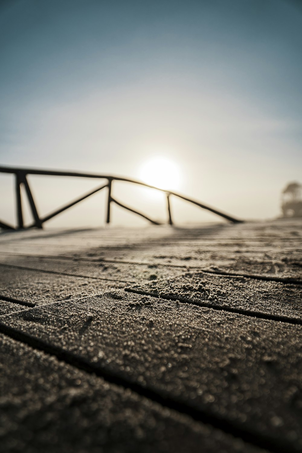 the sun is setting over the beach and the boardwalk