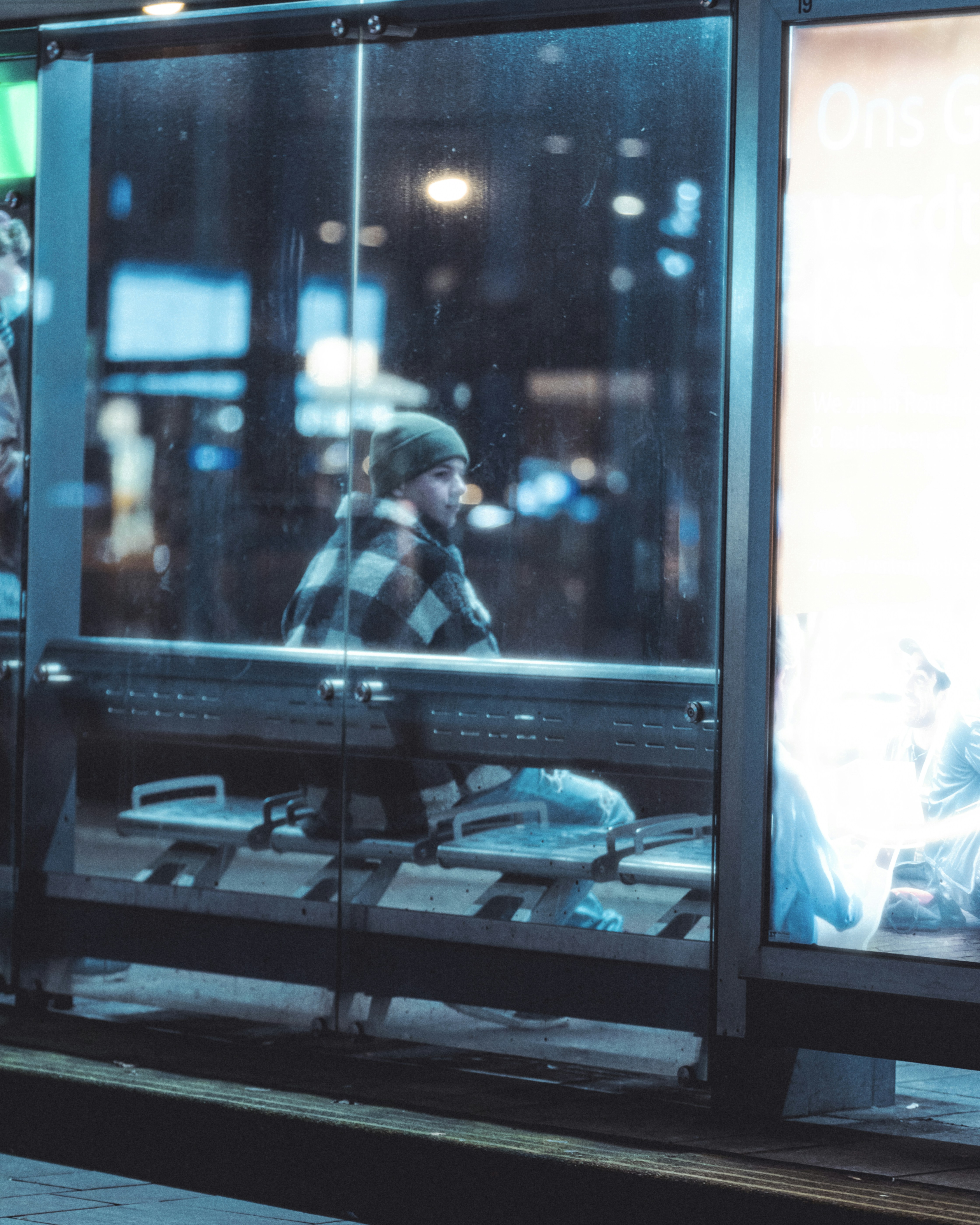 a man sitting on a bench in front of a window