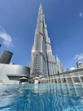 a very tall building towering over a body of water