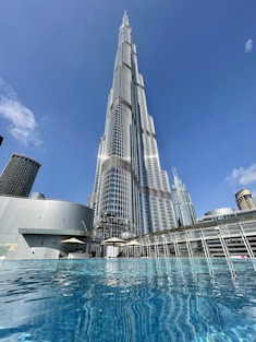 a very tall building towering over a body of water
