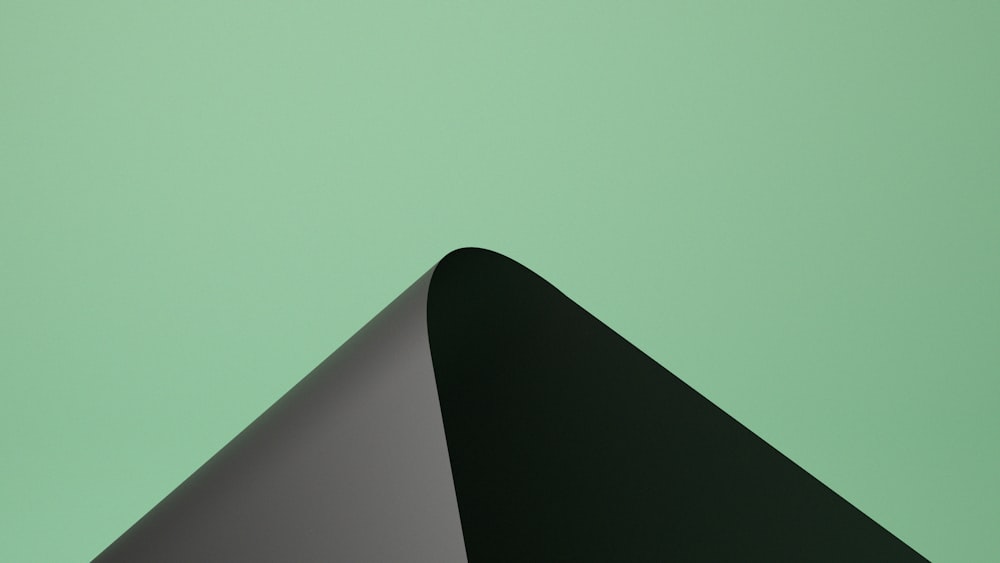 a black and grey triangular on a green background