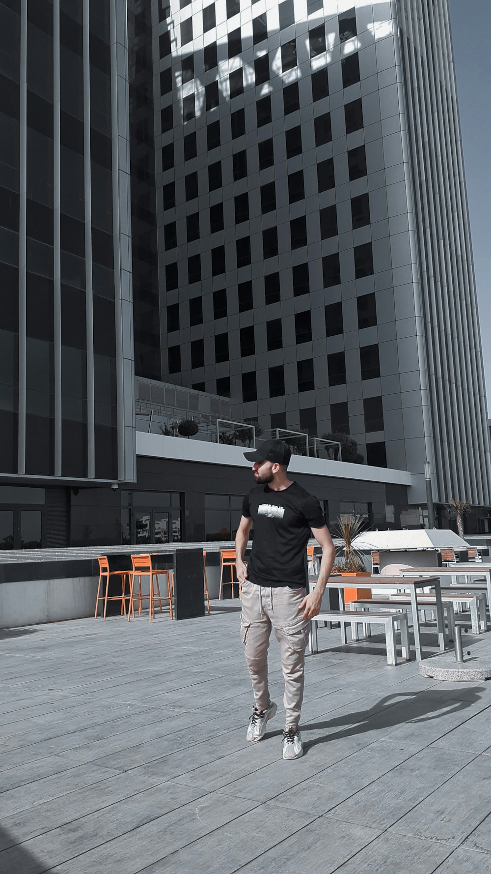 a man standing on top of a wooden floor next to a tall building