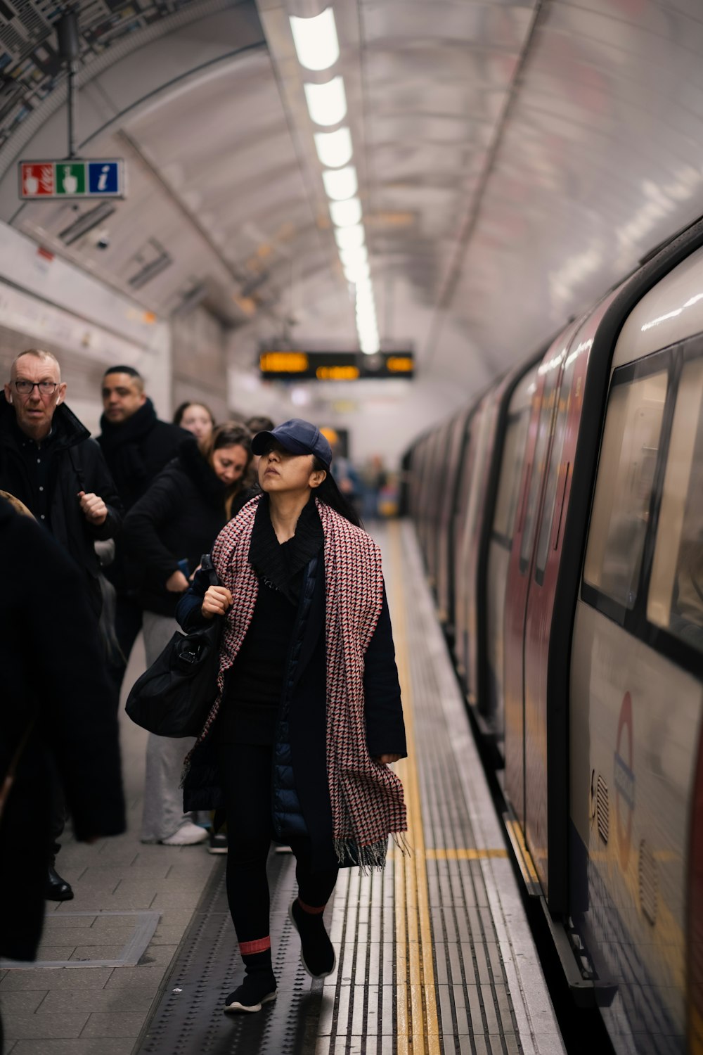 a group of people standing on a subway platform