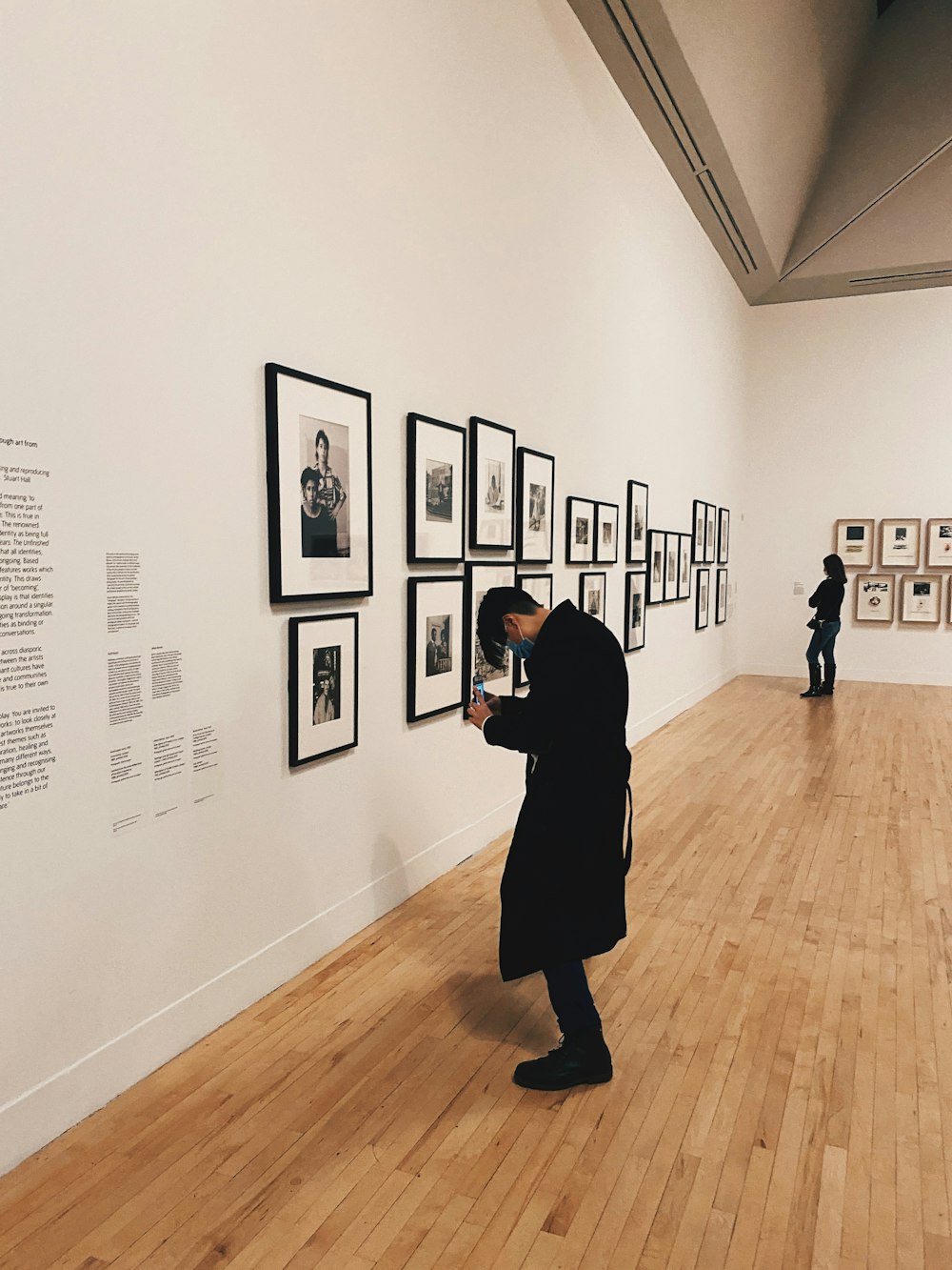 a person looking at pictures on a wall