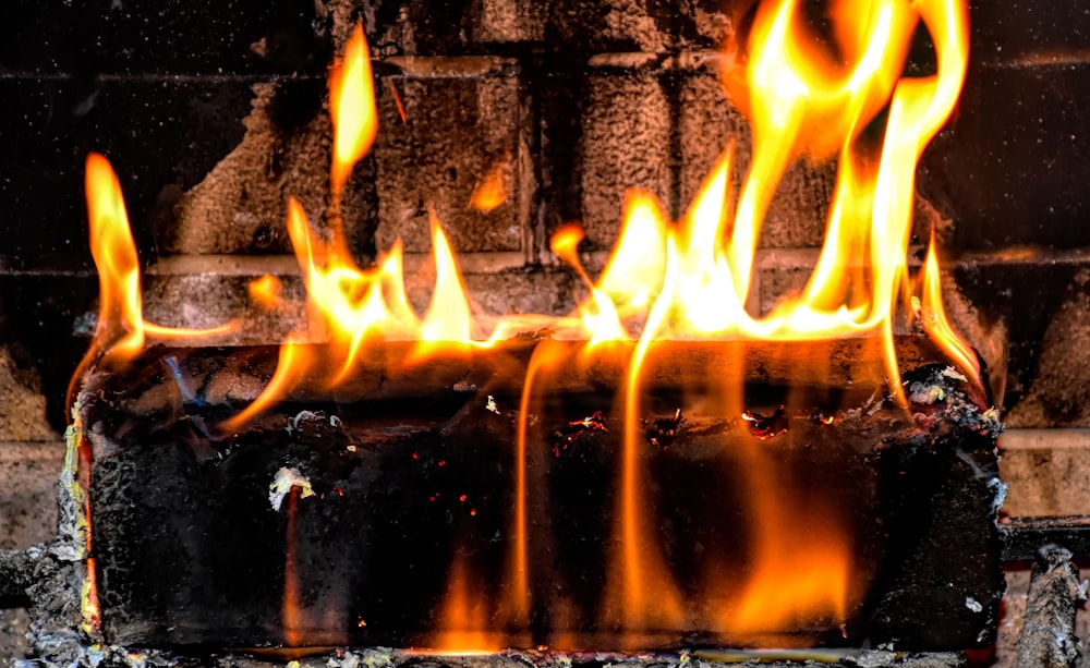 a fire burning inside of a brick oven