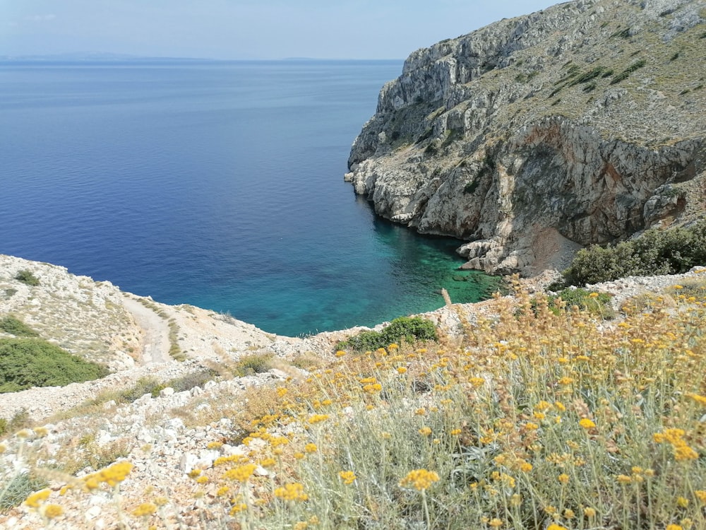 a body of water surrounded by a rocky cliff