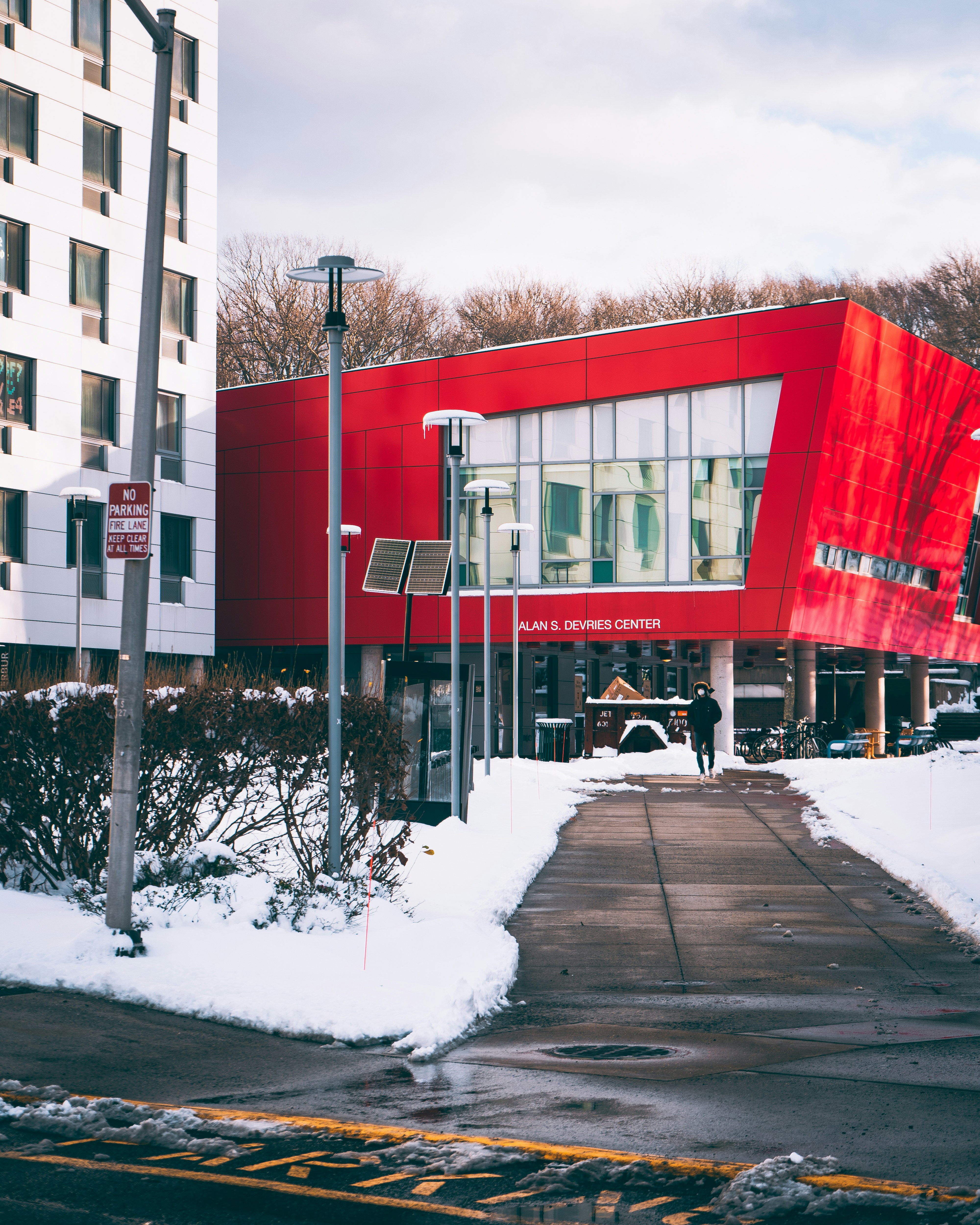 a red building with a red awning on a snowy day