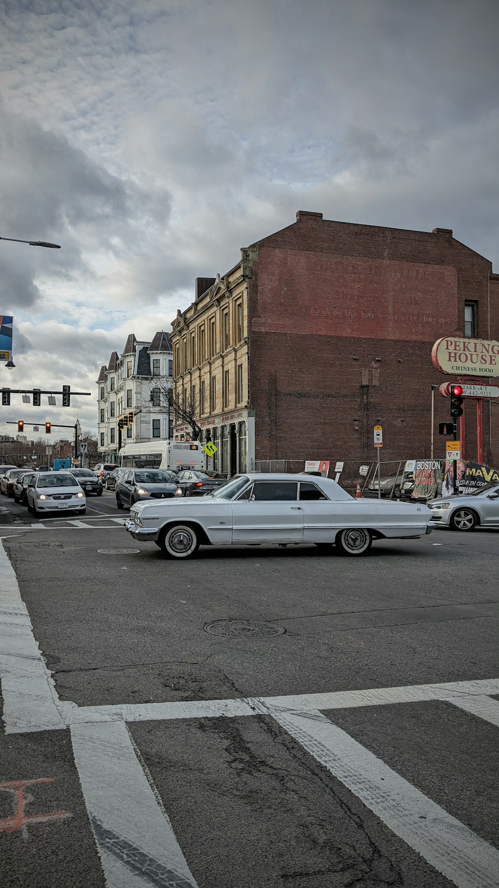 a white car is stopped at an intersection