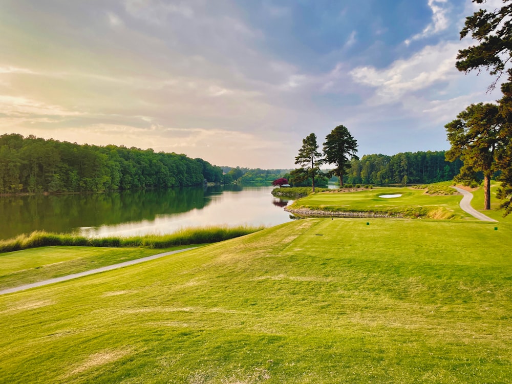 a golf course with a lake in the background