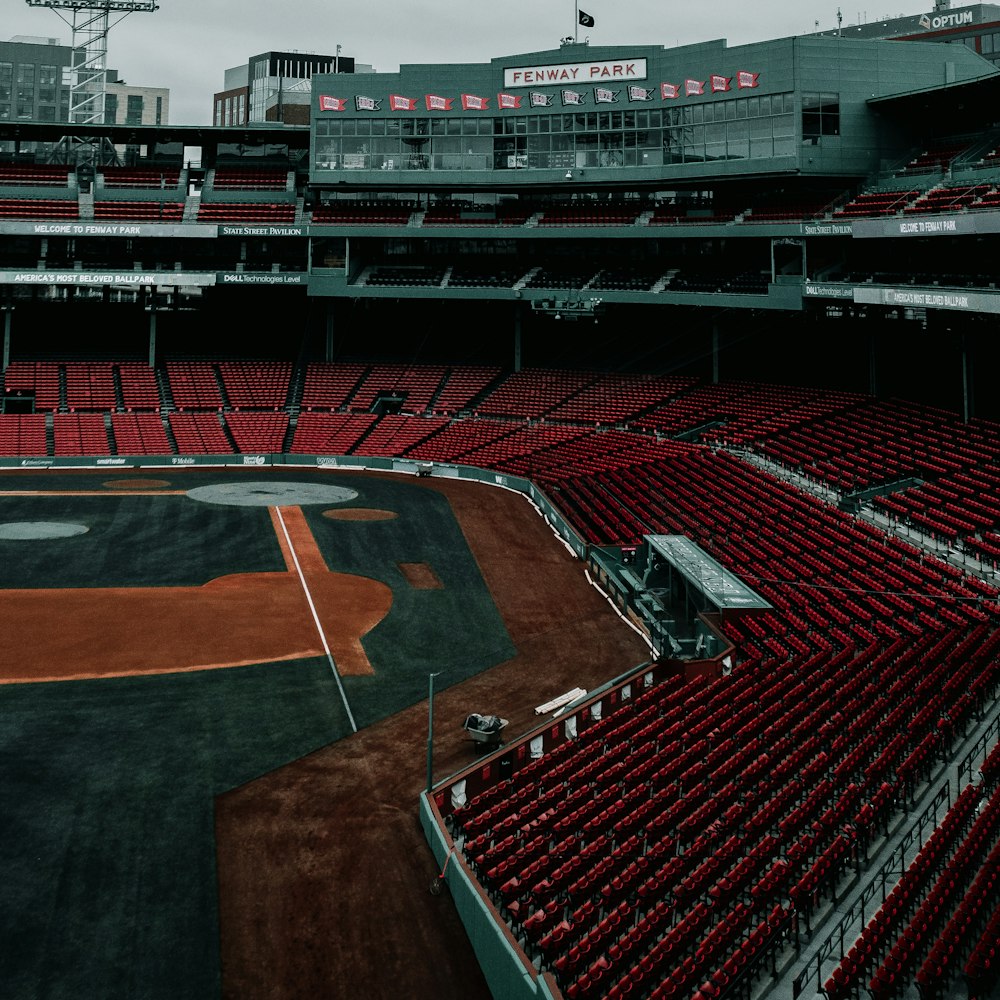 an empty baseball stadium with red seats