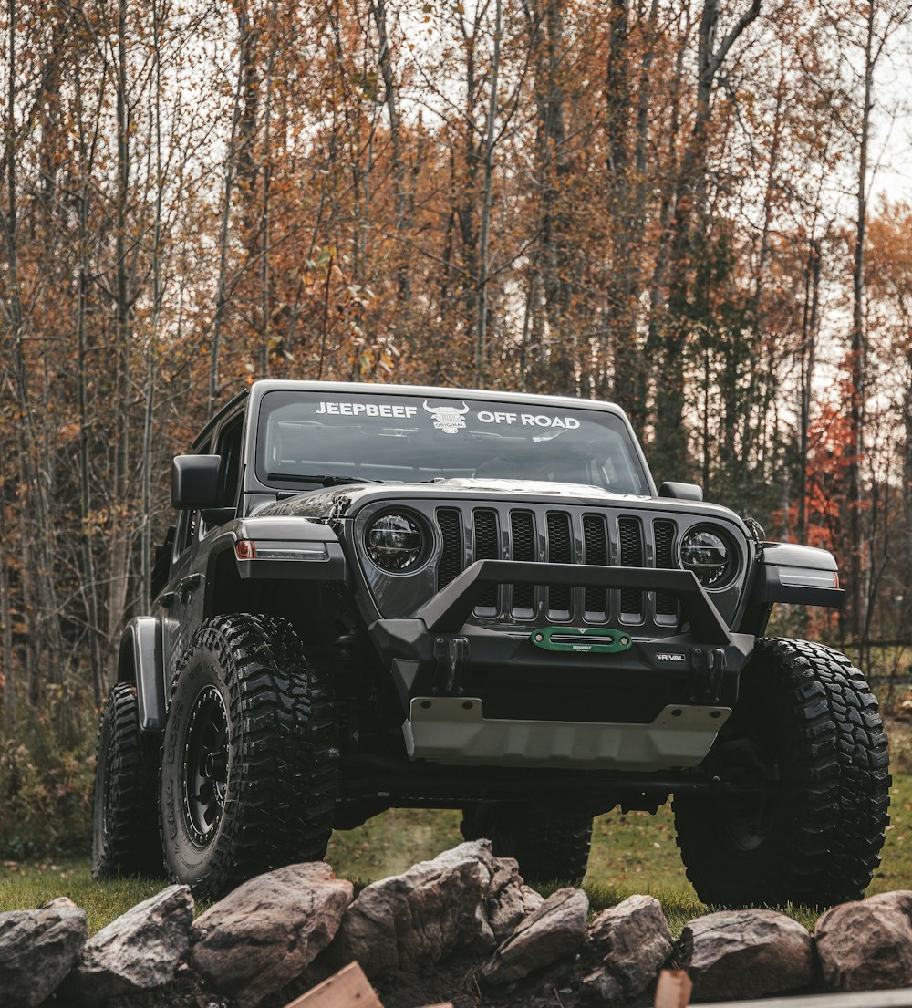 a black jeep is parked in the grass