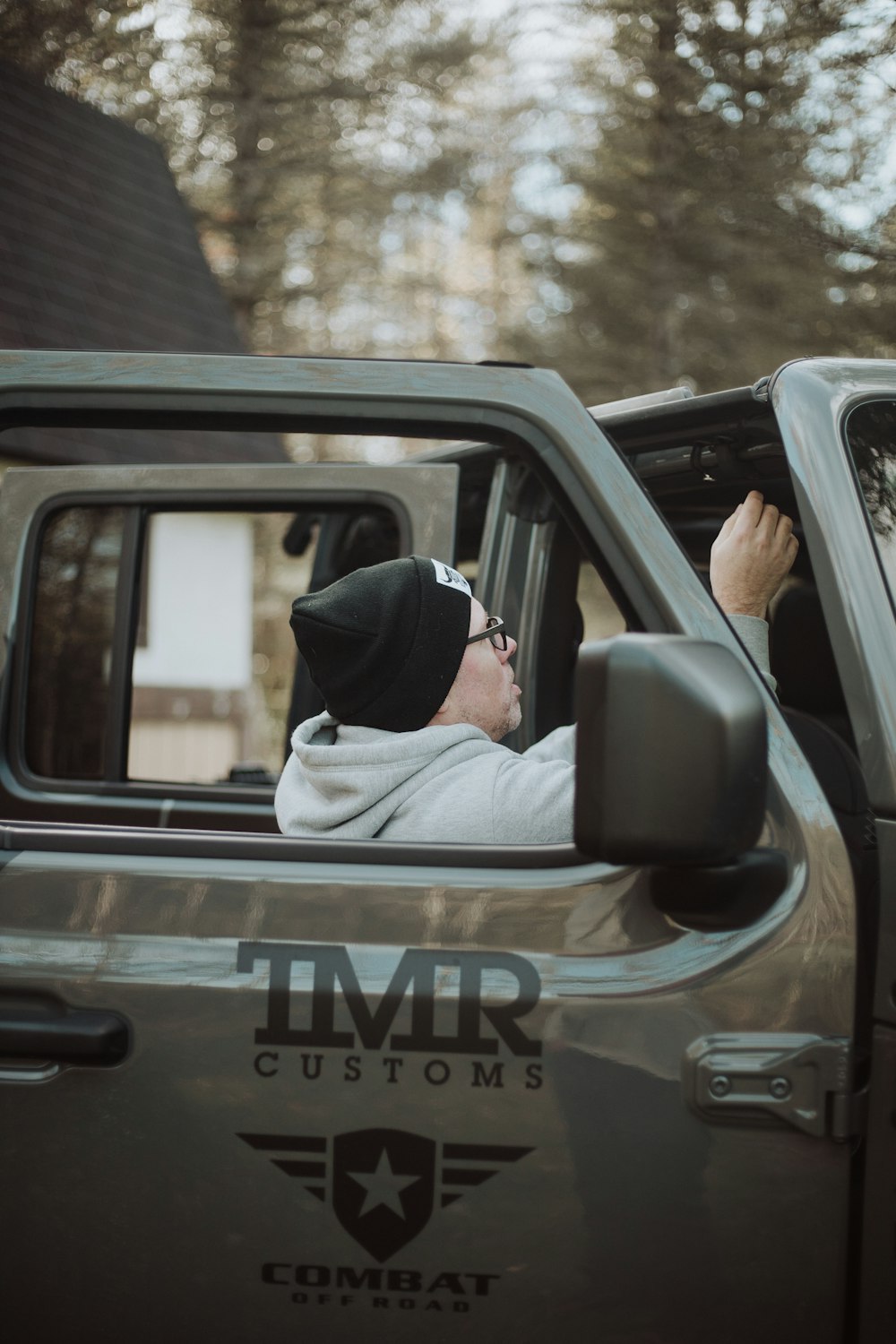 a man sitting in the drivers seat of a truck