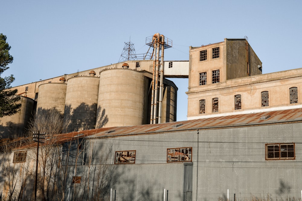 an old factory building with a water tower in the background