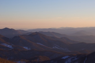 a view of a mountain range at sunset