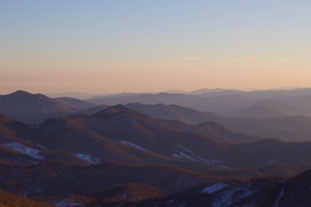 a view of a mountain range at sunset