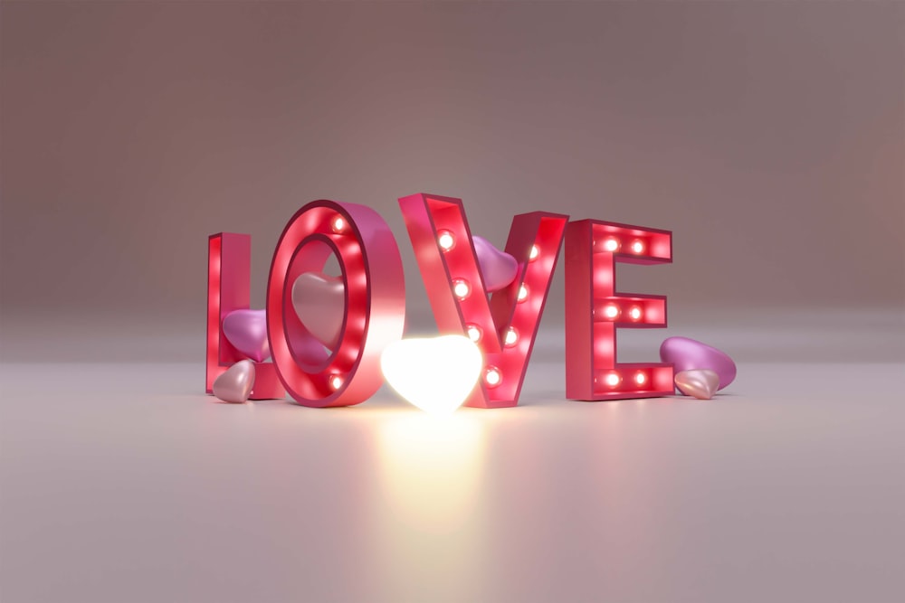 a light up love sign sitting on top of a table