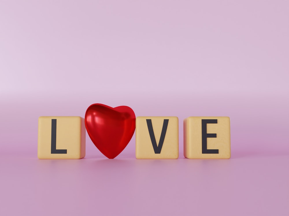 a wooden block spelling love with a red heart