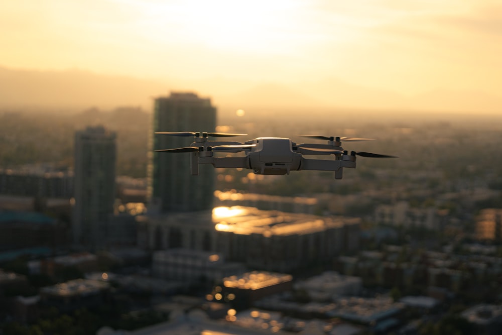 a small white airplane flying over a city